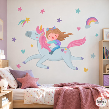 Sticker mural enfant fille montant une licorne avec arc-en-ciel, étoiles et cœurs pour décorer chambre d’enfant