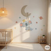 Children’s wall decal featuring a koala on the moon with a swing in the baby room