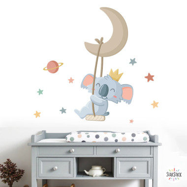 Children’s wall sticker of a koala swinging on the moon with stars for baby nursery wall decoration