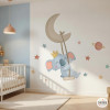 Children’s wall decal featuring a koala on the moon with a swing in the baby room