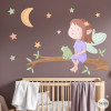 Children’s fairy wall decal sitting on a tree branch with moon, stars and personalised name for baby and girls bedroom decor